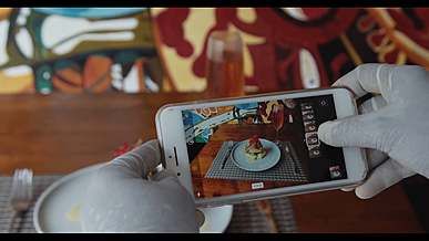 person taking a picture of a gourmet meal