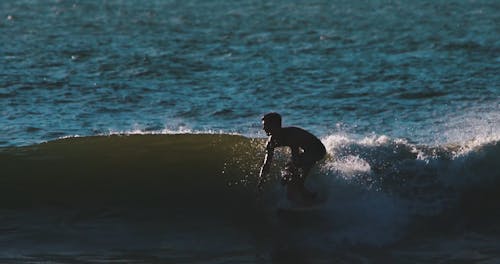 A Man Surfing The Sea Waves