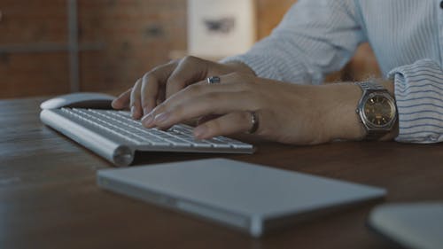 Person Typing on a Magic Keyboard