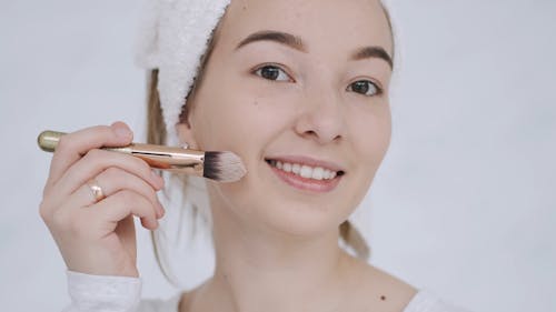 Person Applying a Makeup on Her Face