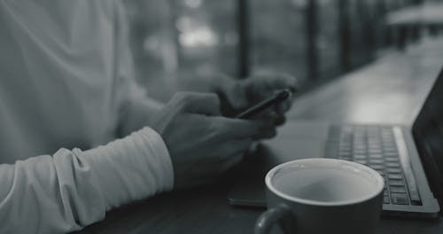 Person Typing on His Mobile Phone