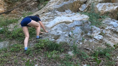 Woman Climbing on a Rock