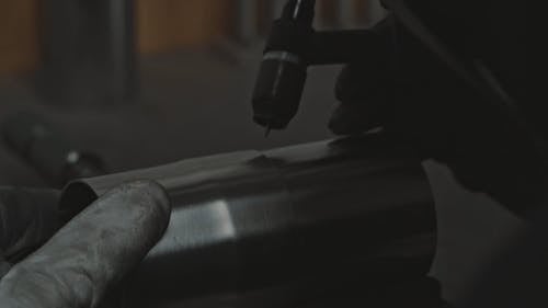 Person Welding a Metal Cylinder