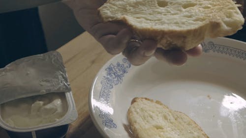 Person Putting a Batter on the Bread