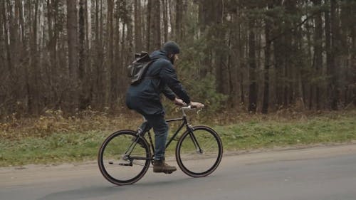Man Riding a Bicycle in a Road