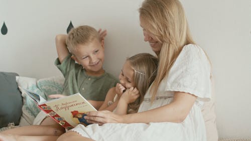 Woman Reading a Story to Her Kids
