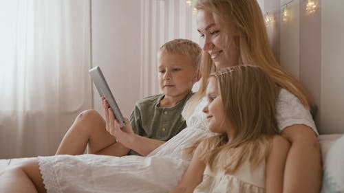 Mother and Her Kids Watching on the Tablet