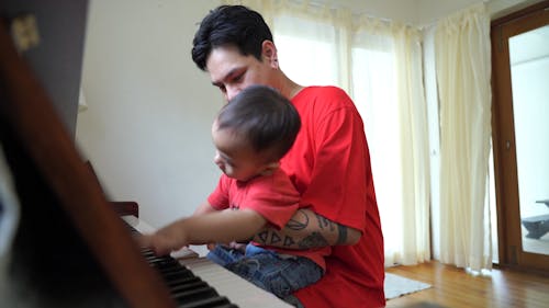 Father and Son Playing with the Piano