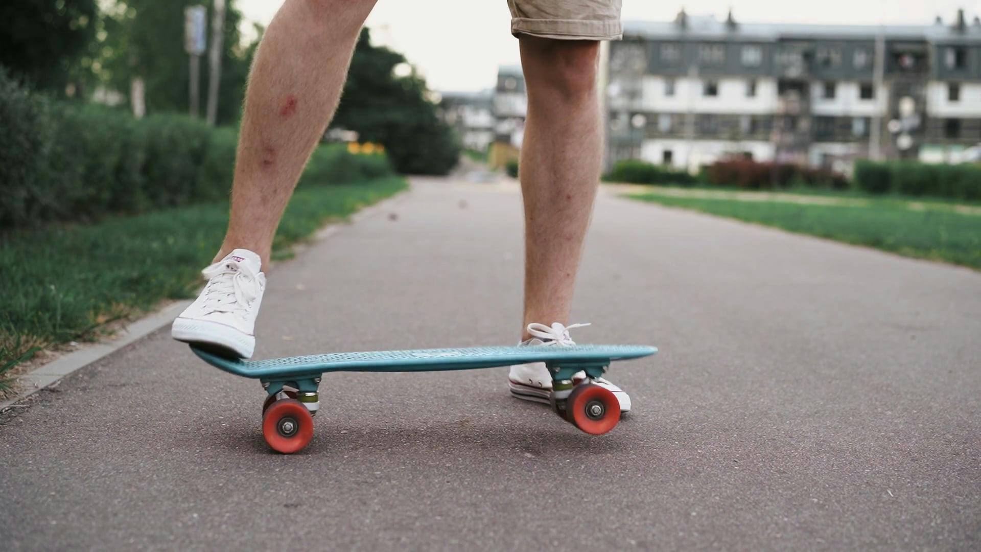 A Person Picking Up a Penny Board · Free Stock Video