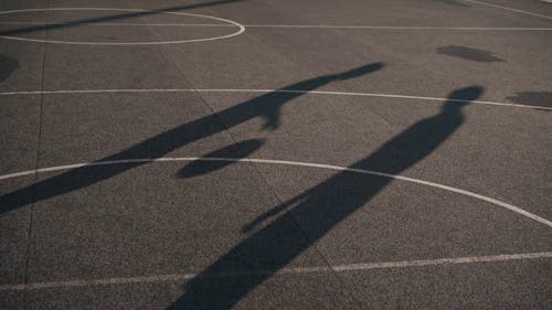 Shadows of People Playing Basketball