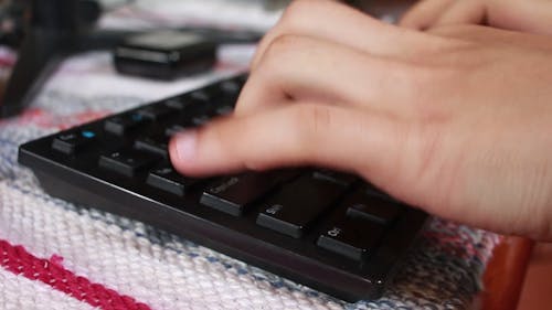 Close-Up View of a Person Typing Using a Keyboard