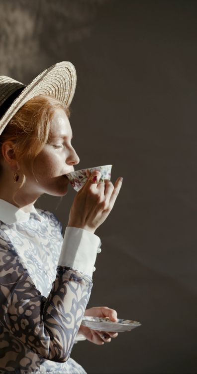 A woman in a hat and dress drinking coffee Free Stock Video Footage ...