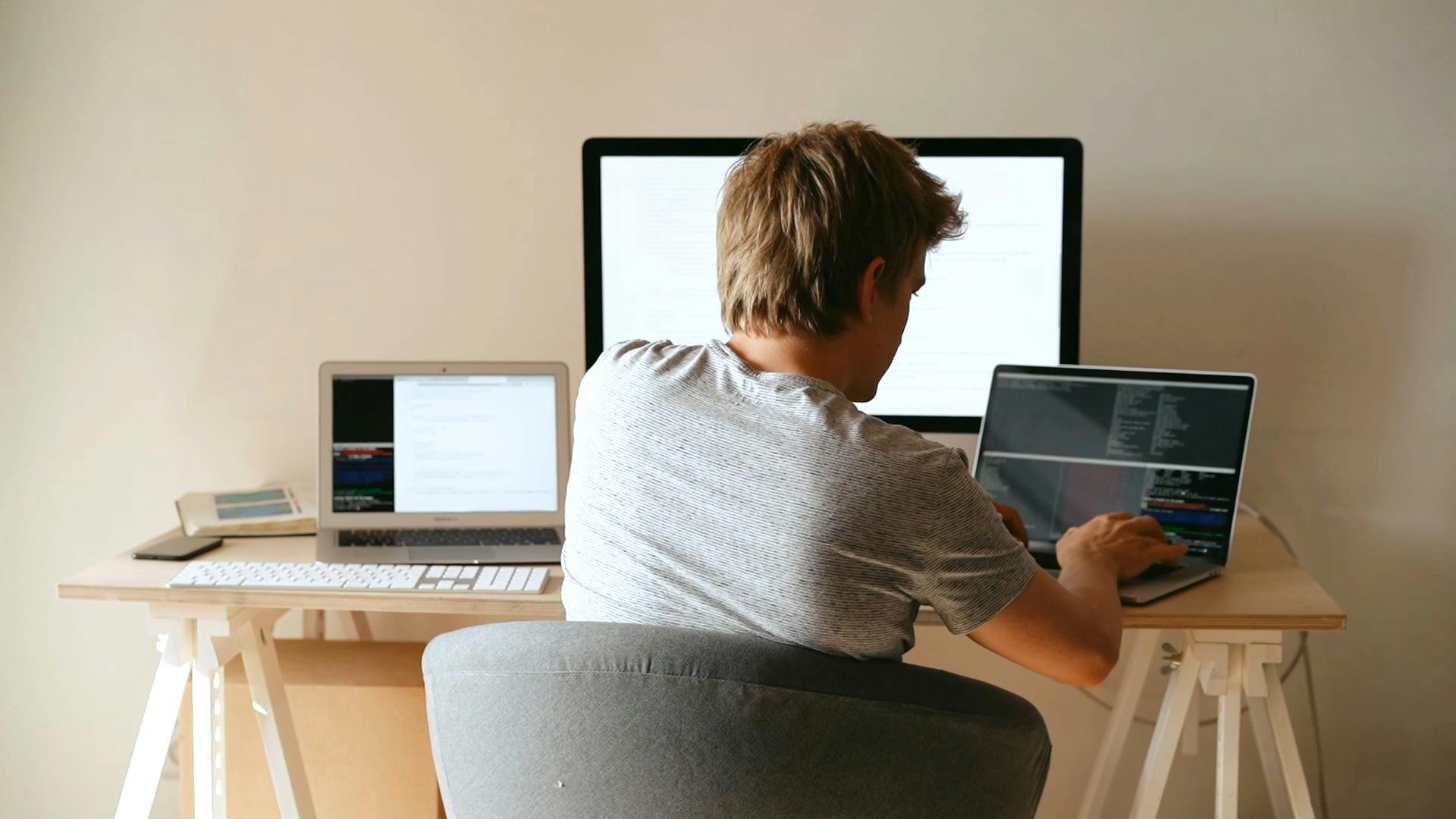 Back View of a Man Using a Laptop · Free Stock Video