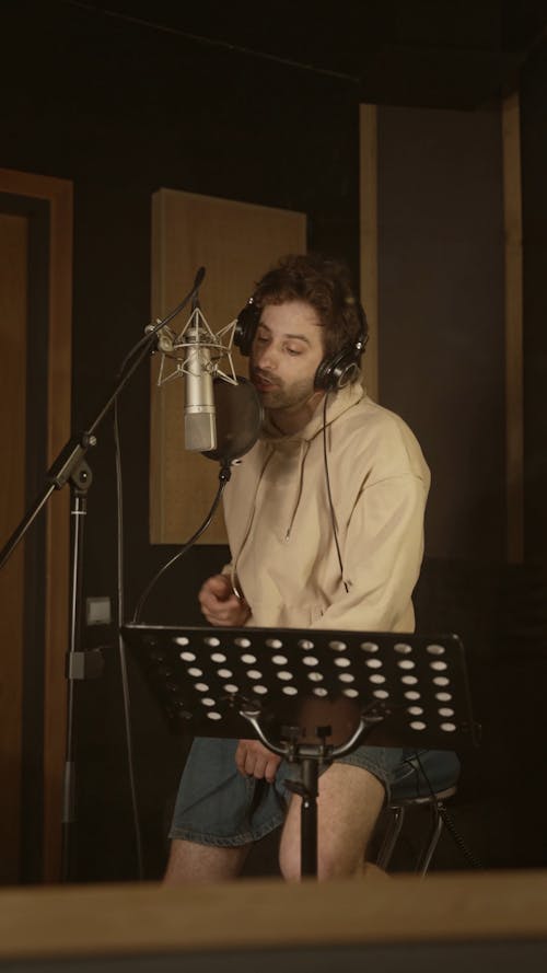 A Man Singing Inside the Music Studio