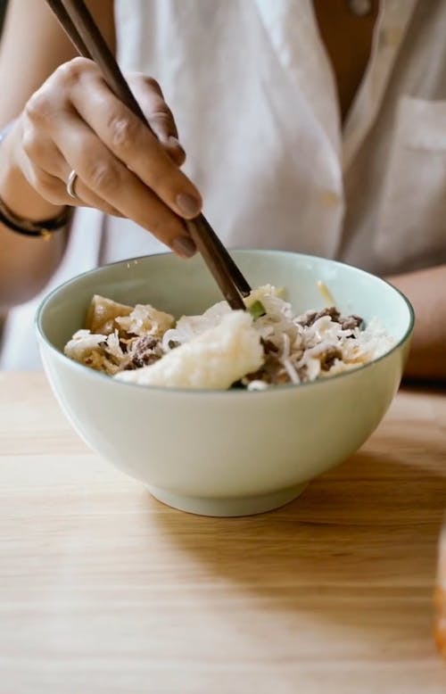 Person Eating with Chopsticks