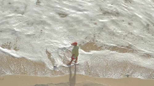 Top View of a Person Standing on Beach Shore