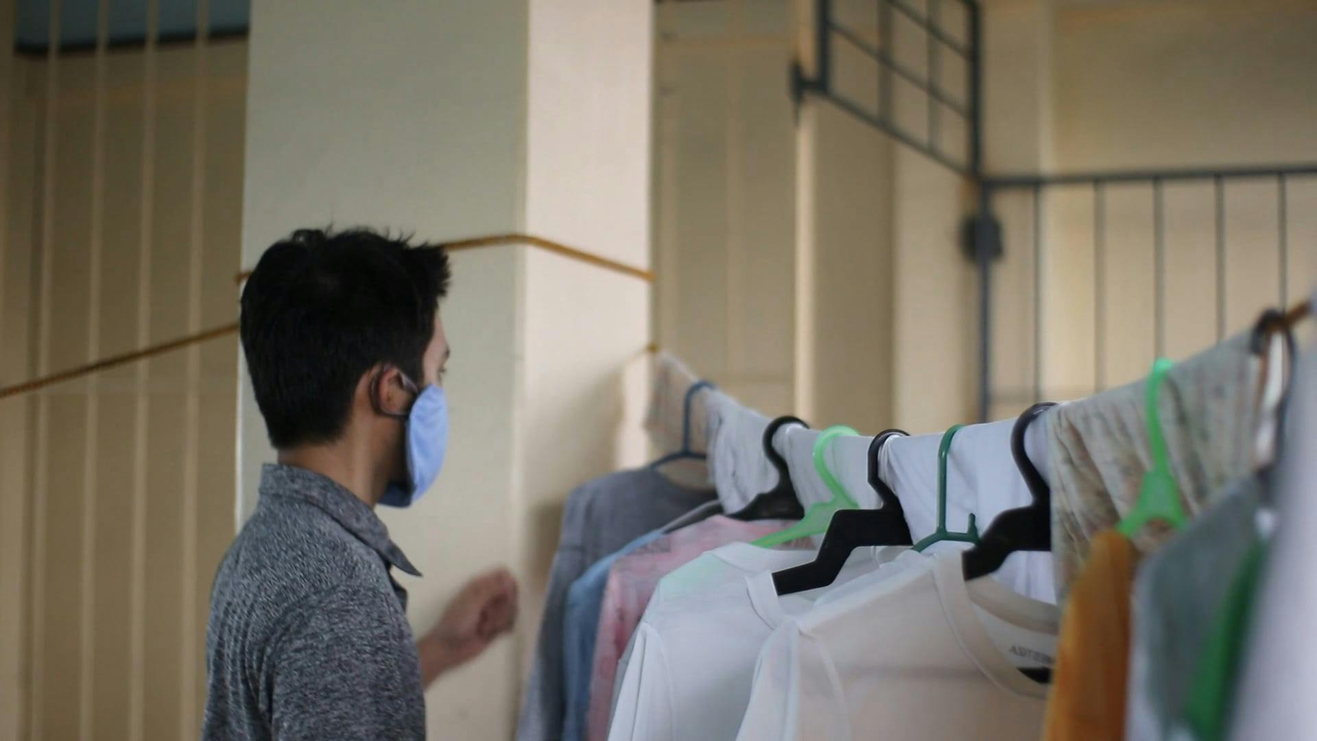 A Man Removing Laundry from the Clothesline Free Stock Video Footage