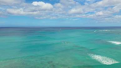 the ocean from above with a boat in the water