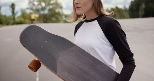 Woman Holding a Longboard