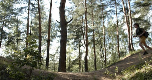 Group of Teenagers Running in the Woods