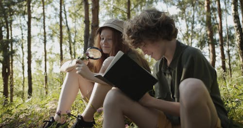 A Boy and a Girl Identifying Flowers and Plants