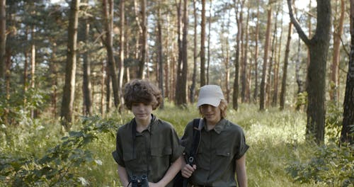 Two Boys Walking In The Woods