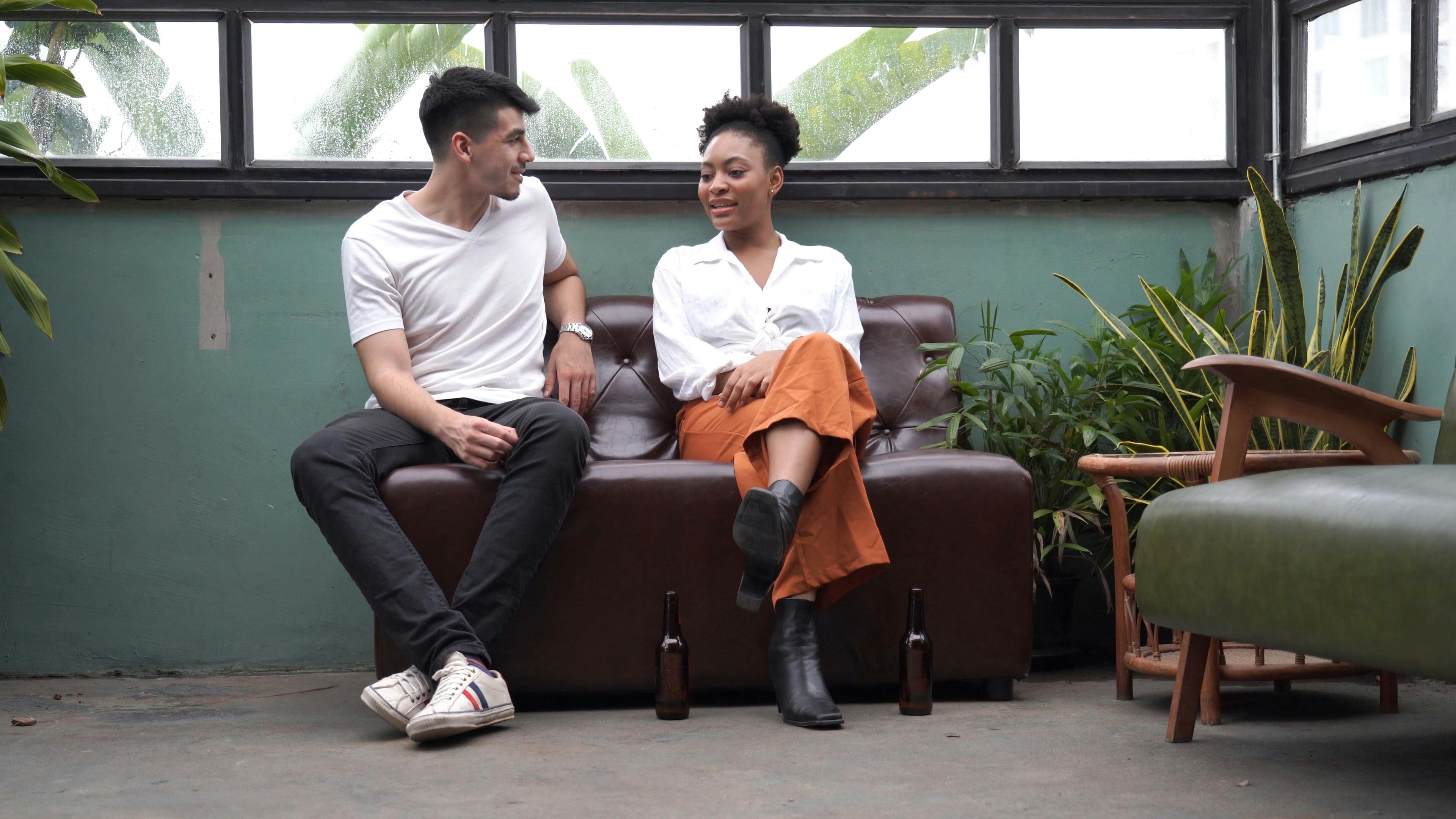 Man and Woman Sitting on a Couch while Talking · Free Stock Video