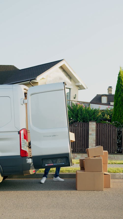 Man taking out Delivery Boxes from Van