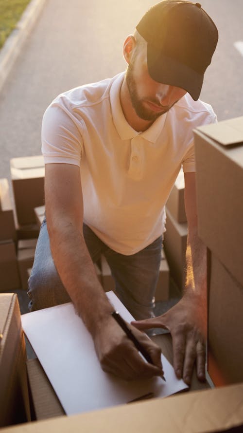 Delivery Man making Checklist for Courier