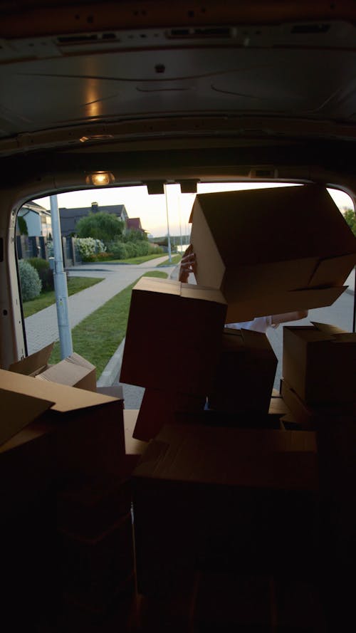Man Loading Delivery Boxes in Van