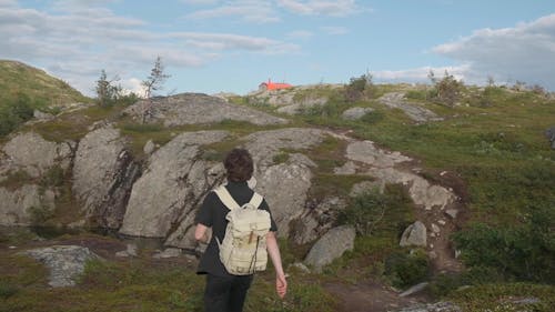 Young Man Hiking Up the Mountains