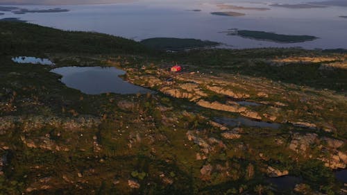 Drone Shot of Red House in the Mountains near Sea