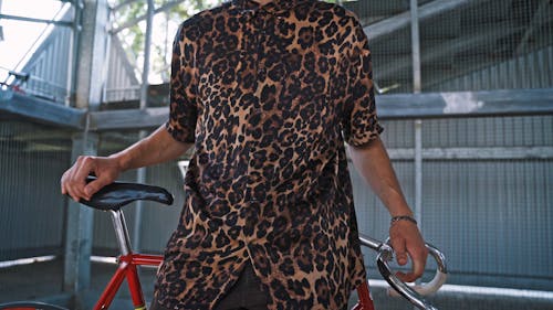 Guy in Cheetah Printed Shirt with Red Bicycle