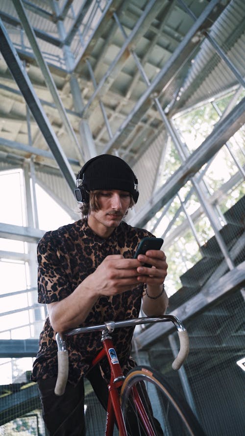 Guy using Mobile Phone on Bicycle