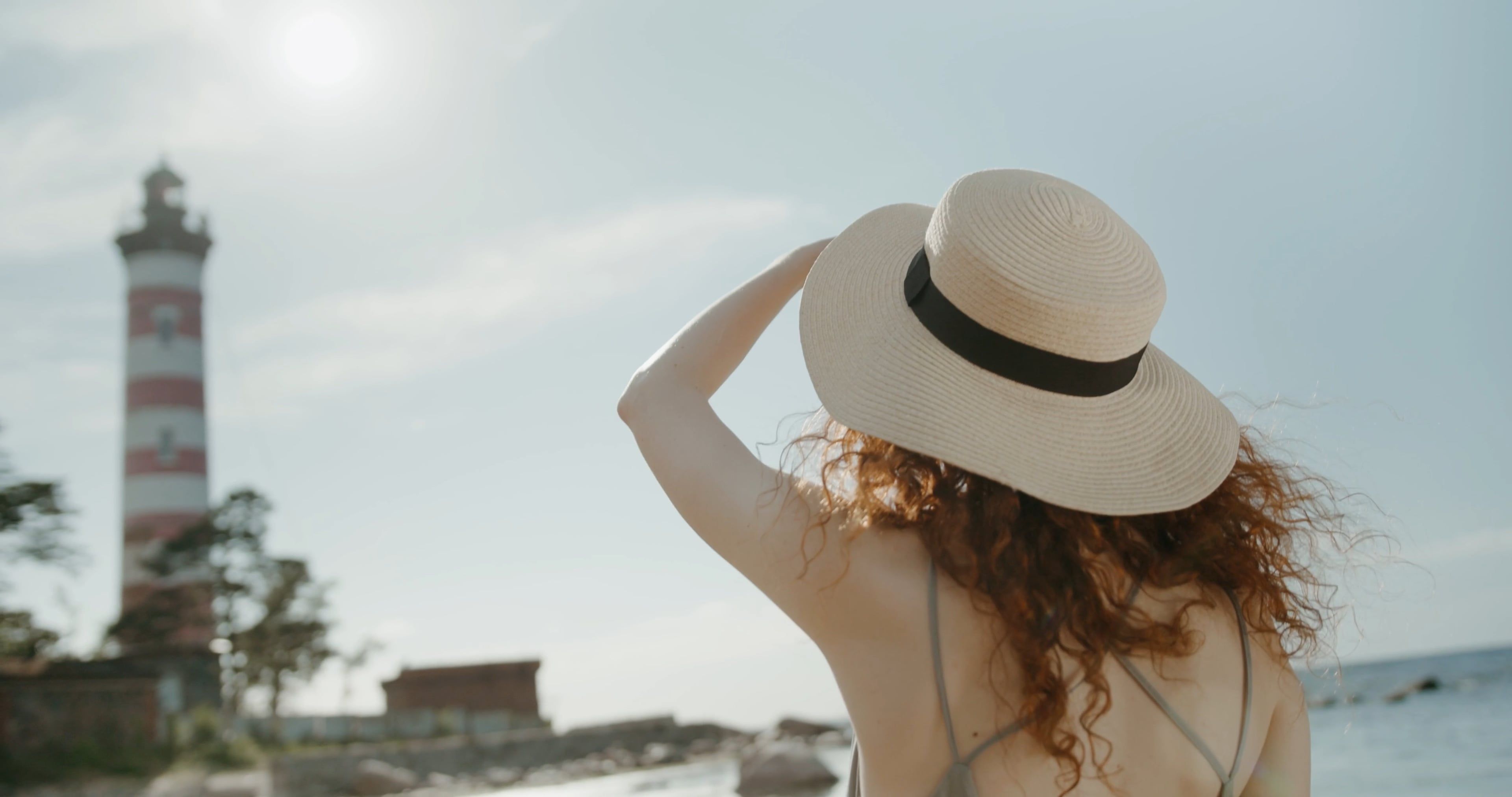 A Woman Looking at the Camera while on the Seashore · Free Stock Video