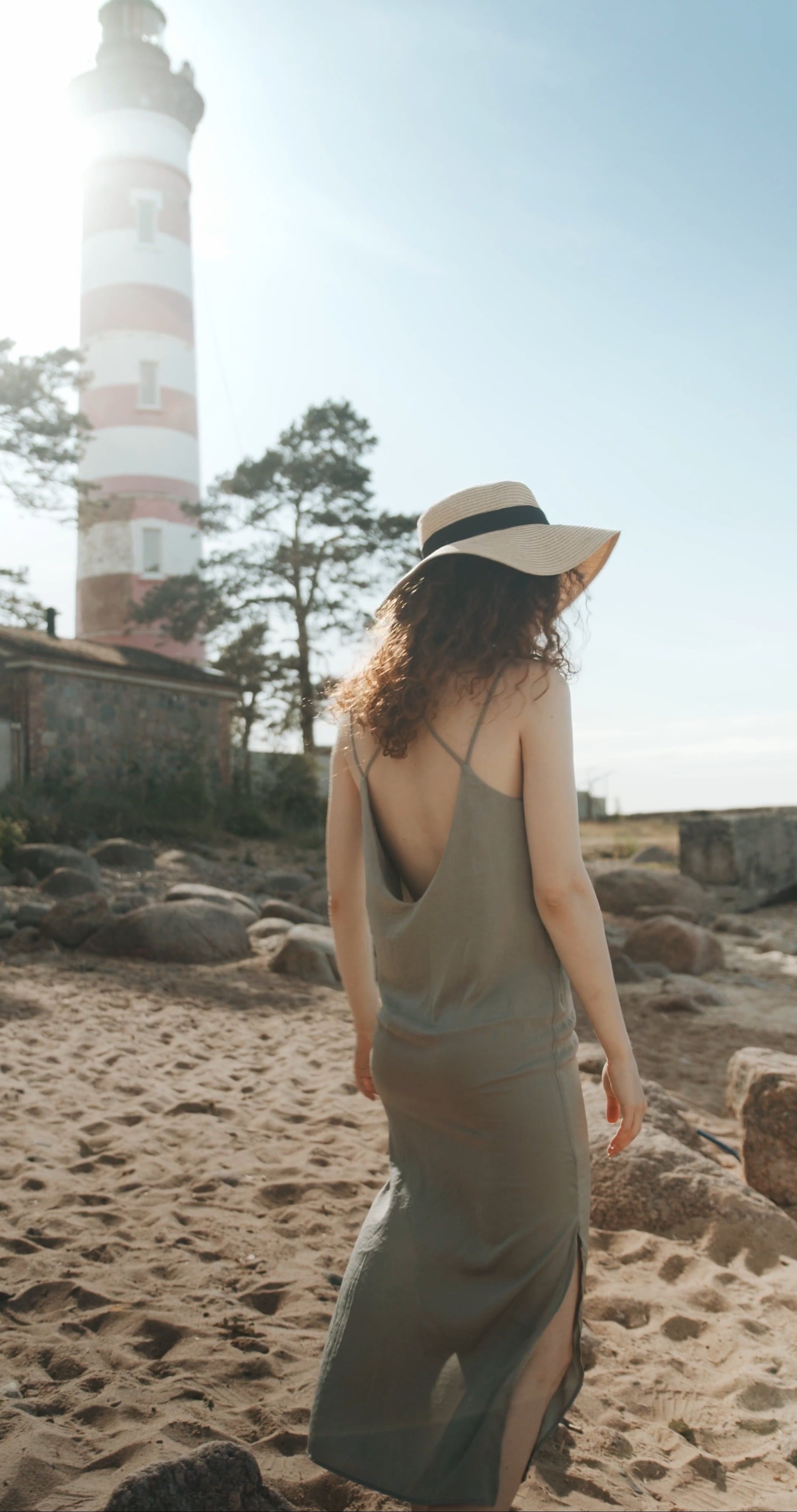 A Woman Walking Near Lighthouse During Sunny Day · Free Stock Video