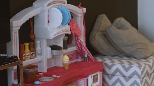 Little Girl Playing with her Kitchen Set