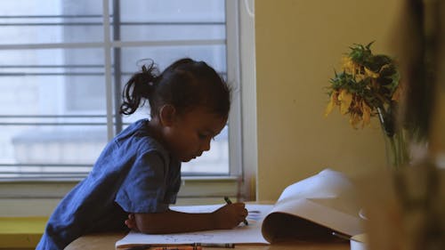 Little Girl Playing with Crayons