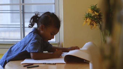 girl coloring with crayons