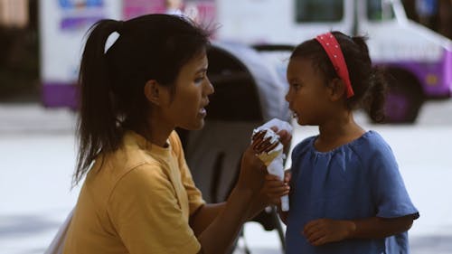 Mother Cleaning Ice Cream from Daughter's Face