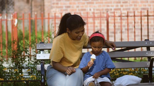 Little Girl Sharing Ice Cream with her Mommy