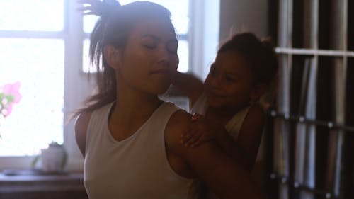 Girl Playing and Kissing her Mother