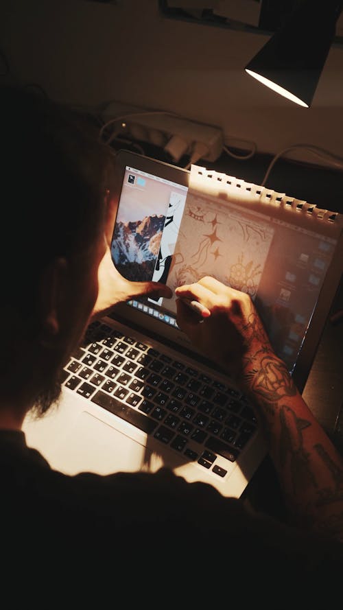 Man Tracing Picture from Laptop Screen