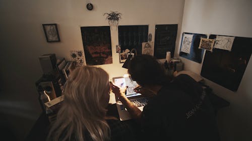 Professional Artist Tracing Tattoo Design from Laptop in his Studio
