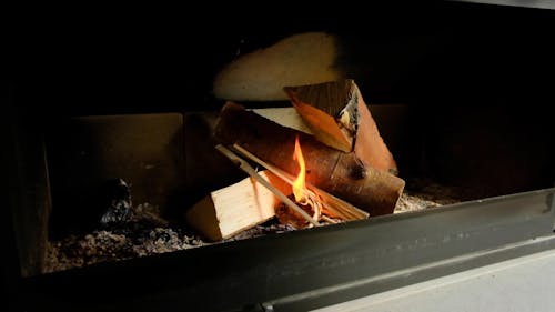 Man Closing Glass Lid of Fireplace in Slow Motion