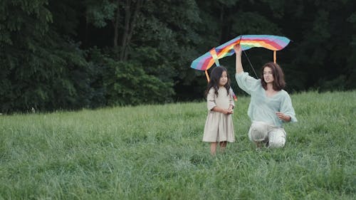 Mom and Daughter Flying Kite