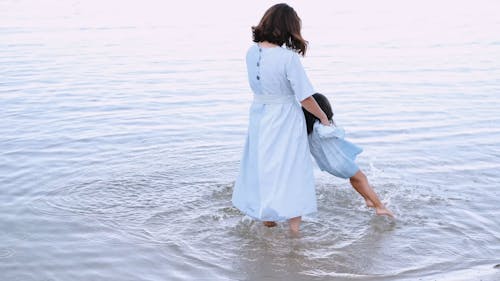 Mother and Daughter Having Fun in Beach