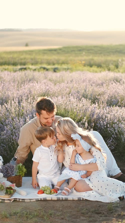 A Happy Family Having a Picnic Outdoors