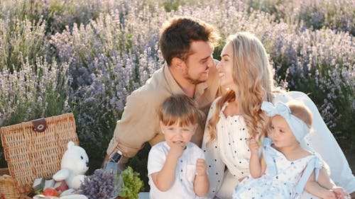 A Happy Family Having a Picnic Outdoors