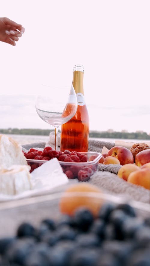 Low-Angle Shot of a Person Pouring a Red Wine